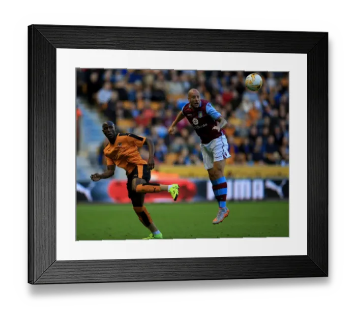 Framed Print : Wolves vs Aston Villa: Pre-Season Clash at Molineux - Hutton vs Afobe Heading Battle