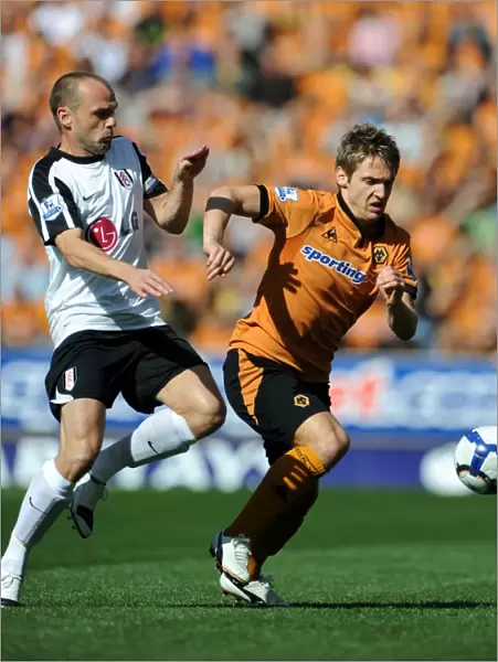 Clash between Kevin Doyle and Danny Murphy: A Intense Moment in Wolverhampton Wanderers vs Fulham Premier League Encounter