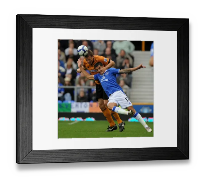 Framed Print : Clash of Titans: Tim Cahill vs. Christophe Berra - Everton vs. Wolverhampton Wanderers in Premier League Soccer