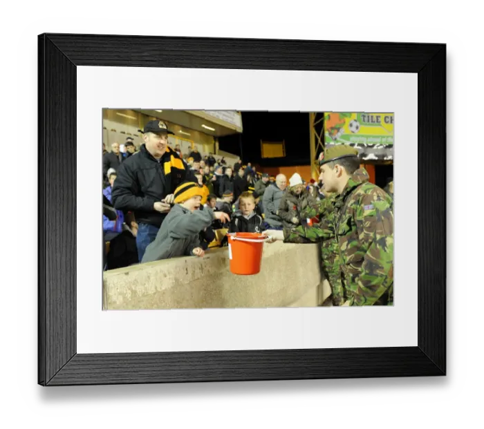 Framed Print : Wolverhampton Wanderers: Soldier Collects Donations in Billy Wright Stand During Wolves vs. Arsenal Premier League Game