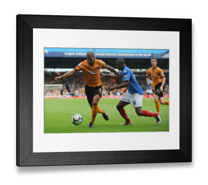 Framed Print : Intense Rivalry: Henry vs. Sowah Clash in Portsmouth vs. Wolverhampton Premier League Showdown