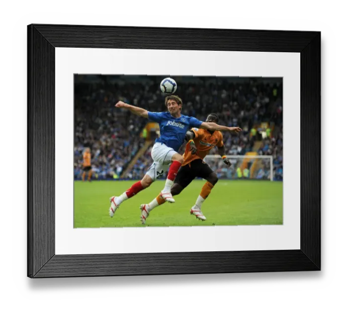 Framed Print : Clash of Titans: Smith vs. Elokobi - Portsmouth vs. Wolverhampton Wanderers, Premier League Showdown Framed Print : Clash of Titans: Smith vs. Elokobi - Portsmouth vs. Wolverhampton Wanderers, Premier League Showdown
