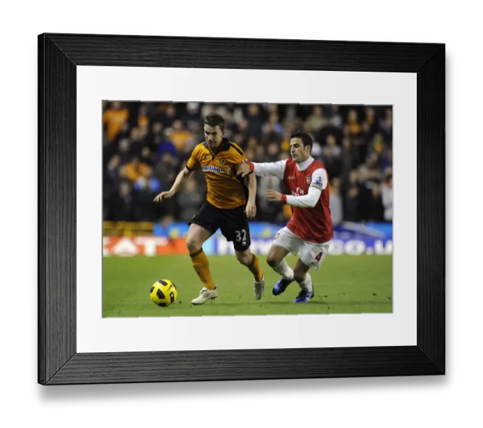 Framed Print : Wolverhampton Wanderers vs Arsenal: A Clash of Football Titans - A Battle between Kevin Foley and Cesc Fabregas Framed Print : Wolverhampton Wanderers vs Arsenal: A Clash of Football Titans - A Battle between Kevin Foley and Cesc Fabregas