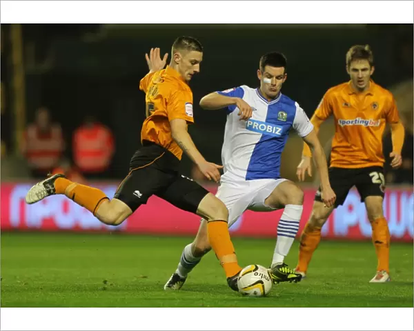 Tense Moment: Jake Cassidy's Goal Attempt Thwarted by Scott Dann (Wolverhampton Wanderers vs. Blackburn Rovers)
