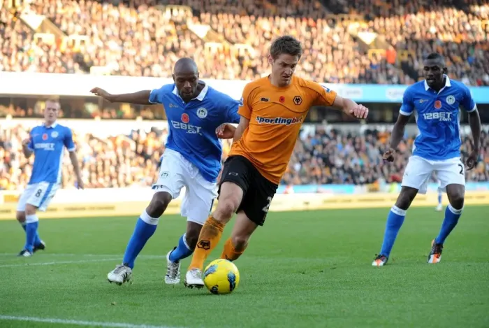 Framed Print : Clash between Kevin Doyle and Emmerson Boyce: A Battle in the Wolverhampton Wanderers vs Wigan Athletic Barclays Premier League Match Framed Print : Clash between Kevin Doyle and Emmerson Boyce: A Battle in the Wolverhampton Wanderers vs Wigan Athletic Barclays Premier League Match