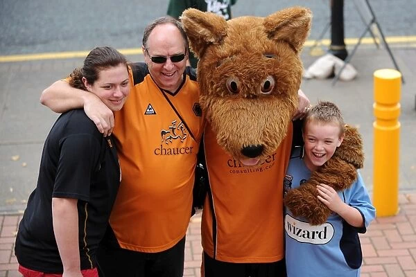 Wolfie with fans. Fans pose for a photograph with Wolves mascot Wolfie