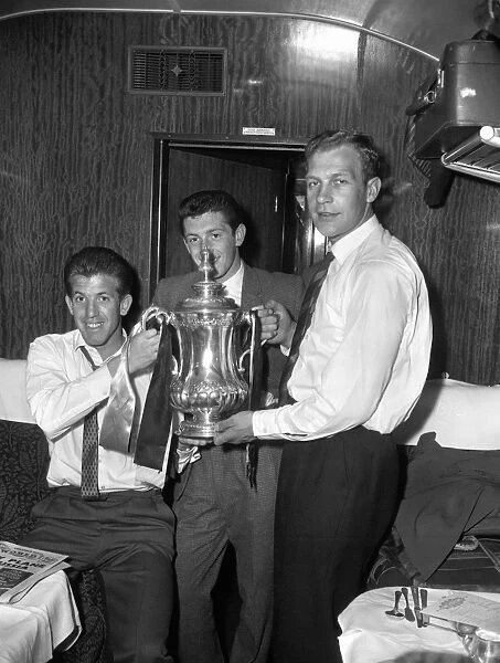 Wolverhampton Wanderers FA Cup Victory: Peter Broadbent, Gerry Mannion, and Malcolm Finlayson Celebrate on the Train Back to Wolverhampton