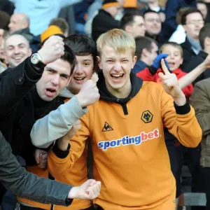 Euphoric Wolves Fans Celebrate Premier League Victory on the Pitch: Burnley vs. Wolverhampton Wanderers