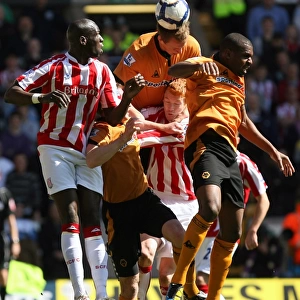 Intense Battle for the Ball: Wolverhampton Wanderers vs Stoke City - Christophe Berra's Headed Clash in Barclays Premier League
