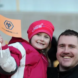 Jubilant Wolves Fans Celebrate Premier League Victory over Blackpool with Flag Wave at Molineux Stadium