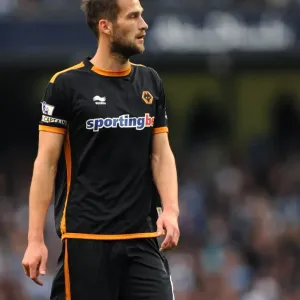 A Tense Moment in the Premier League: Roger Johnson's Focus Against Manchester City