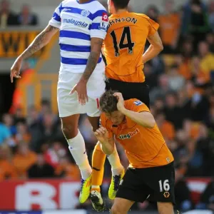 Three Titans Clash: A Tense Battle between Wolverhampton Wanderers Johnson, Bothroyd, and Berra in the Wolves vs. Queens Park Rangers Showdown