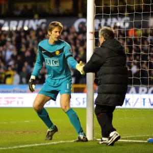 An Unusual Delivery: Edwin van der Sar Receives an Energy Biscuit During Wolverhampton Wanderers vs Manchester United (Barclays Premier League) An Unusual Delivery: Edwin van der Sar Receives an Energy Biscuit During Wolverhampton Wanderers vs Manchester United (Barclays Premier League)