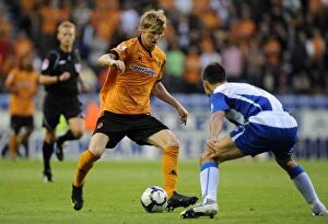 Images Dated 18th August 2009: Clash of the Midfield Maestros: Andy Keogh vs Jason Koumas at DW Stadium - Wolverhampton Wanderers