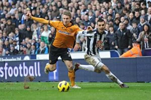 Images Dated 21st February 2011: Clash of the Midlands: Kevin Doyle vs. Paul Scharner - A Premier League Battle between