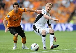 Images Dated 21st August 2011: Clash of the Wings: Jarvis vs. Duff in the Barclays Premier League - Wolverhampton Wanderers vs
