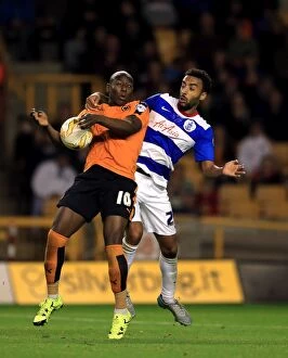 Sky Bet Championship - Wolves v Queens Park Rangers - Molineux Stadium Collection: Intense Rivalry: Afobe vs. Perch Battle in Wolves vs. QPR Championship Clash at Molineux