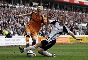Derby County Vs Wolves Collection: Intense Rivalry: Keogh vs. Albrechtsen Clash in Wolverhampton Wanderers vs Derby County