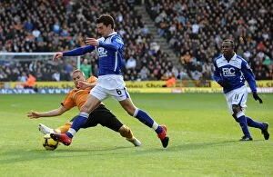 Wolves v Birmingham Collection: Intense Rivalry: Michael Kightly's Slide Tackle on Liam Ridgewell