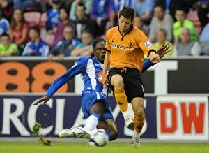 Wigan Athletic Vs Wolves Collection: Matthew Jarvis vs Mario Melchiot: Intense Clash Between Wolverhampton Wanderers and Wigan Athletic