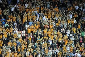 Premiership Collection: Four Thousand Strong: Wolverhampton Wanderers Unwavering Support at Wigan Athletic's DW Stadium