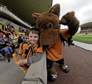 Matches 08-09 Prints: Wolverhampton Wanderers: 2008-09 Championship Win - Triumphant Fan and Mascot with the Trophy