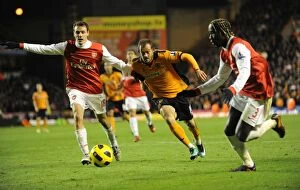Images Dated 11th November 2010: Wolverhampton Wanderers vs Arsenal: Steven Fletcher's Intense Battle with Squillaci and Sagna