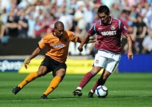 Images Dated 15th August 2009: Wolves vs West Ham: Luis Jimenez vs Karl Henry - The Intense Clash at Molineux